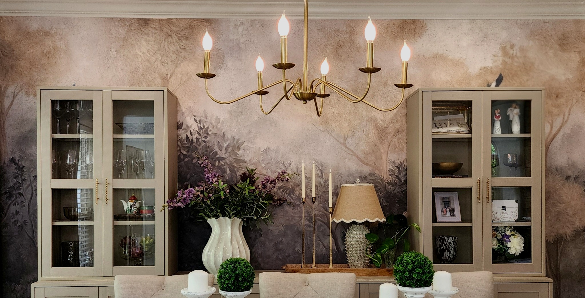 Sunlit living room with linen sofa, travertine table and arched window — interior design by Harland Home Interiors